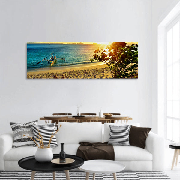 Young couple enjoying sunset on the beach island of El Nido panoramic canvas wall art