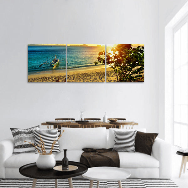 Young couple enjoying sunset on the beach island of El Nido panoramic canvas wall art