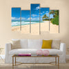 Untouched sandy beach with palms trees and azure ocean in background Multi panel canvas wall art