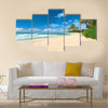 Untouched sandy beach with palms trees and azure ocean in background Multi panel canvas wall art