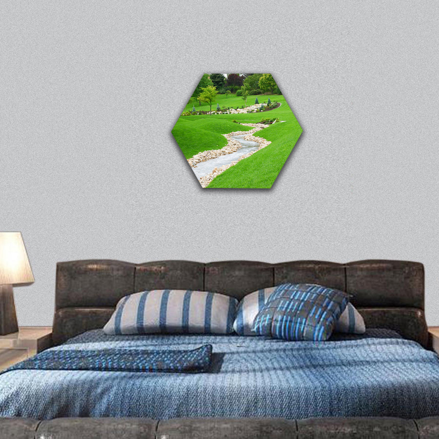 Stream of water flowing through grassy hills hexagonal canvas wall art