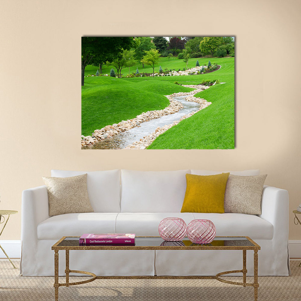 Stream of water flowing through grassy hills with trees Multi Panel Canvas Wall Art
