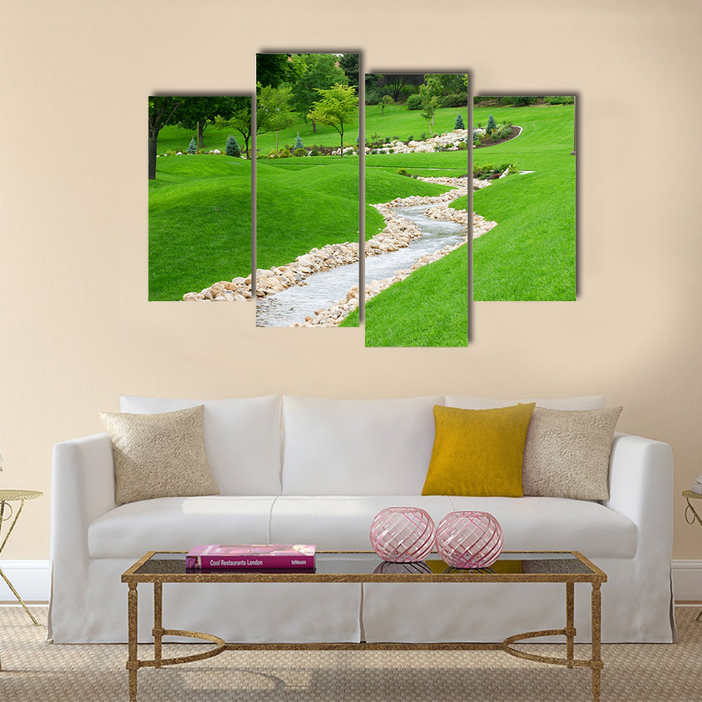 Stream of water flowing through grassy hills with trees Multi Panel Canvas Wall Art
