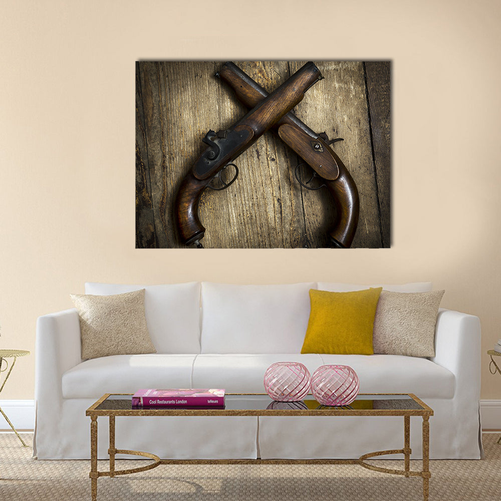 Two vintage pistols on wooden background multi panel canvas wall art