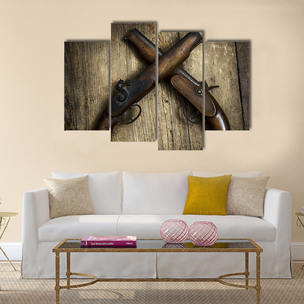 Two vintage pistols on wooden background multi panel canvas wall art