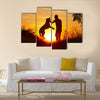 Young man with his yellow labrador retriever in nature - back lit  Multi panel canvas wall art