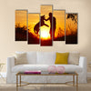 Young man with his yellow labrador retriever in nature - back lit  Multi panel canvas wall art