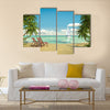 Frontal view of a caribbean beach with deck chairs and boat Multi panel canvas wall art