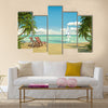 Frontal view of a caribbean beach with deck chairs and boat Multi panel canvas wall art