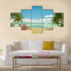 Frontal view of a caribbean beach with deck chairs and boat Multi panel canvas wall art