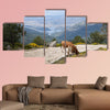 Two cows grazing in Casillas Mountain Pass, Iruelas Valley Natural Park, Avila, Spain, with the El Bruguillo, Multi Panel Canvas Wall Art