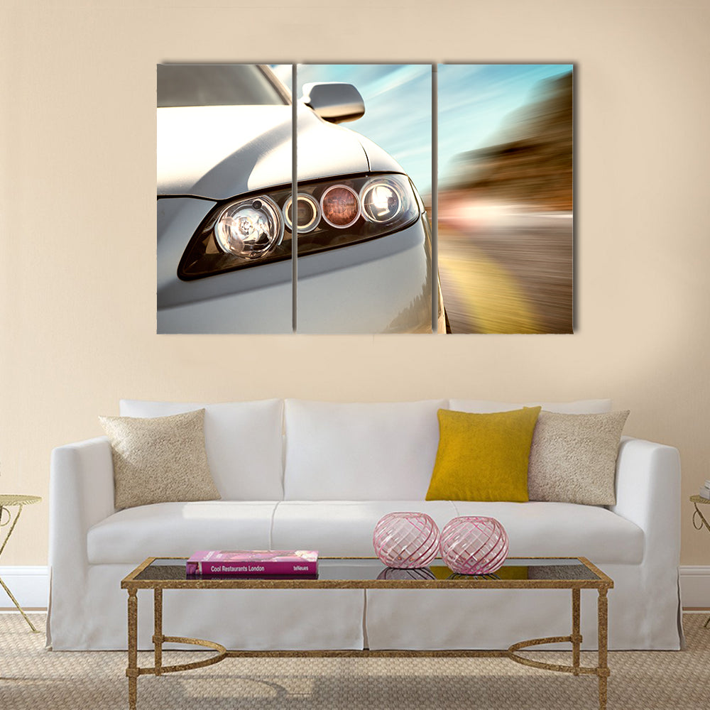 A car driving on a motorway at high speeds, overtaking other cars Multi panel canvas wall art