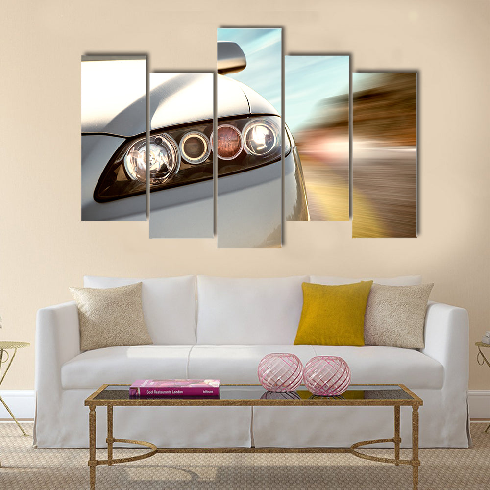 A car driving on a motorway at high speeds, overtaking other cars Multi panel canvas wall art