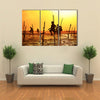 Silhouettes Of The Traditional Fishermen At The Sunset Near Galle In Sri Lanka Multi Panel Canvas Wall Art