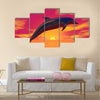 Dolphin jumping upon the ocean by beautiful red sunset Multi Panel Canvas Wall Art