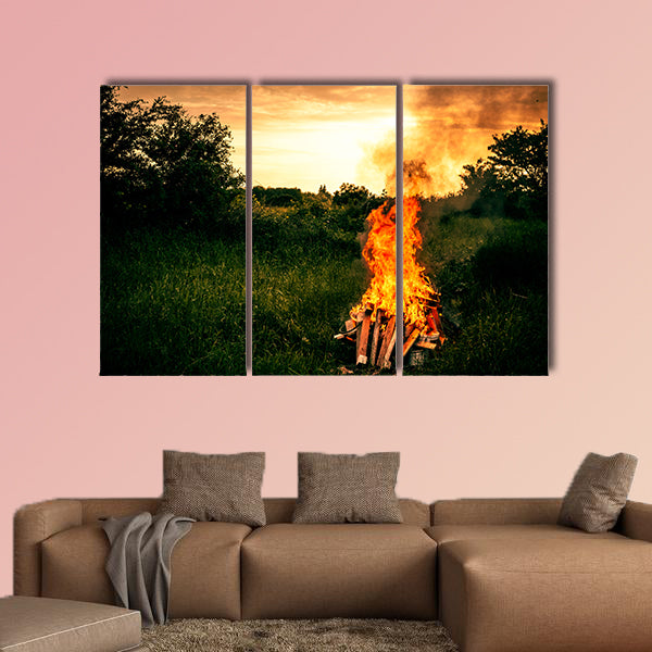 Bonfire at a camp in natural surroundings multi panel canvas wall art