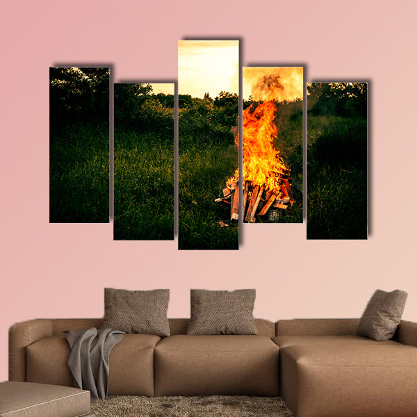 Bonfire at a camp in natural surroundings multi panel canvas wall art