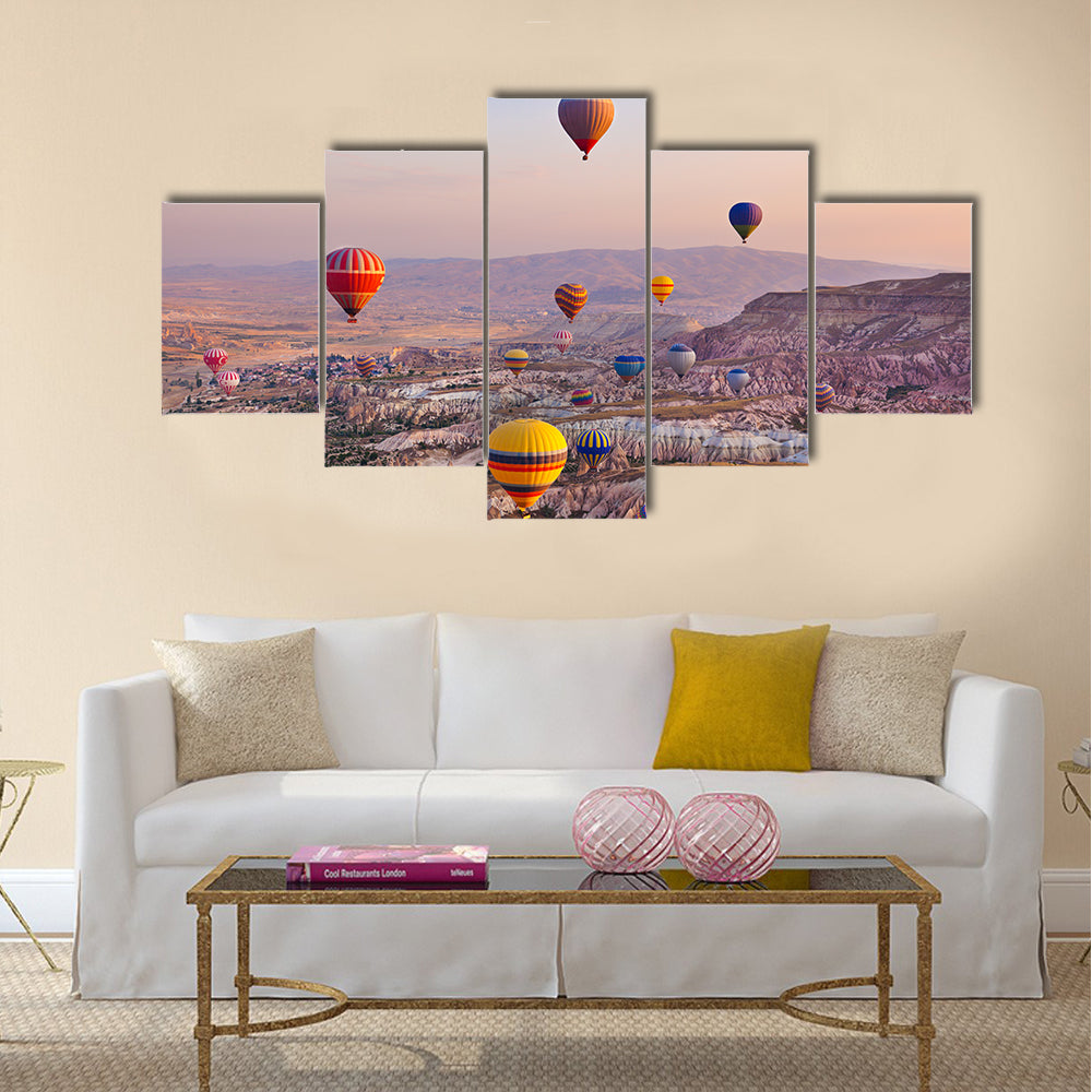 Hot air balloon flying over rock landscape at Cappadocia Turkey, multi panel canvas wall art