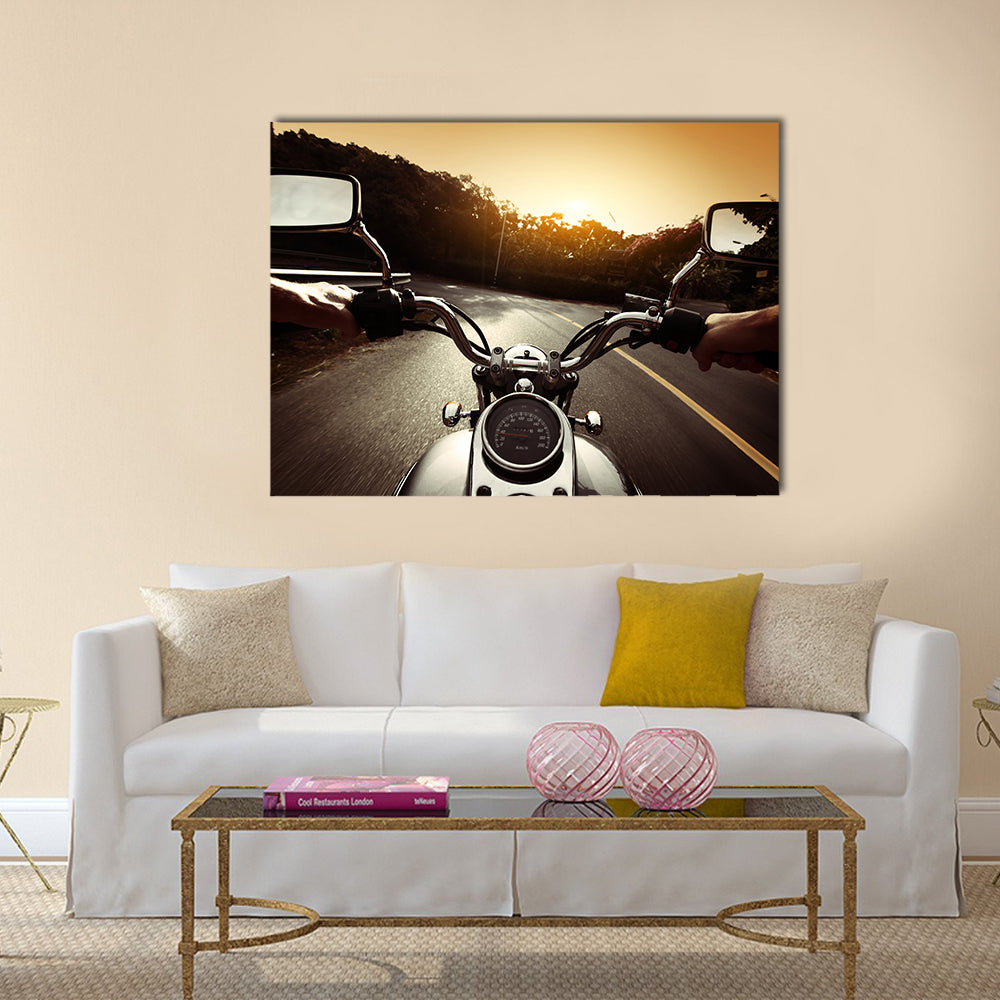 Driver riding motorcycle on an asphalt road through forest Multi panel canvas wall art