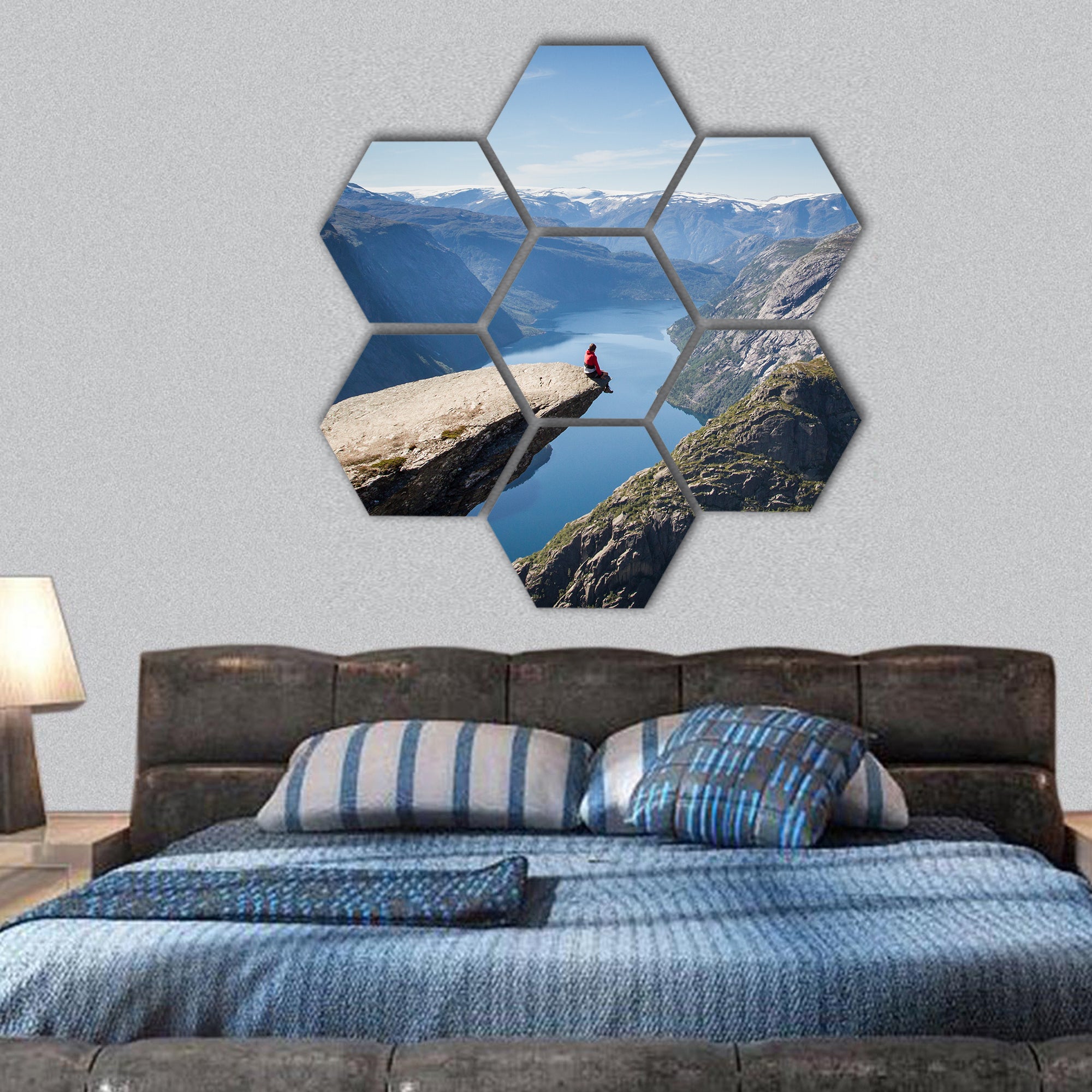 man sitting on trolltunga in Norway hexagonal canvas wall art