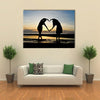 Two girls make heart with sea and sun down background multi panel canvas wall art