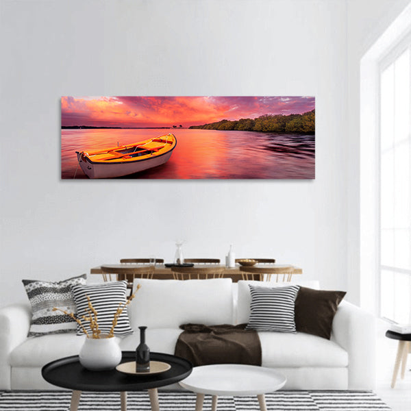 A rowboat watches an amazing sunset panoramic canvas wall art