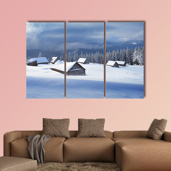 Winter landscape with wooden houses in a mountain valley multi panel canvas wall art