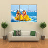 Happy People having Fun on Banana boat Multi Canvas Print Wall Art