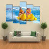 Happy People having Fun on Banana boat Multi Canvas Print Wall Art