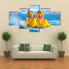 Happy People having Fun on Banana boat Multi Canvas Print Wall Art