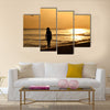 A young woman taking a walk on the beach at sunset on Sanibel Island – enhanced and added birds, Multi panel canvas wall art