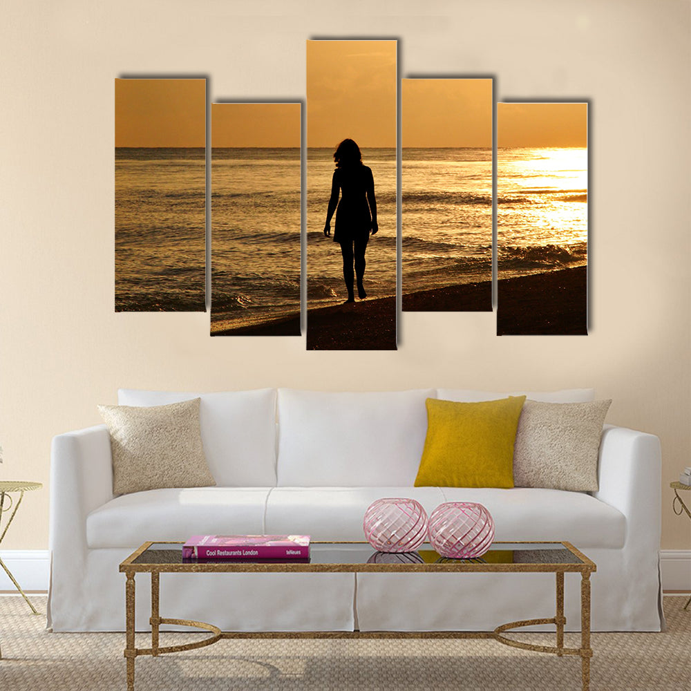 A young woman taking a walk on the beach at sunset on Sanibel Island – enhanced and added birds, Multi panel canvas wall art