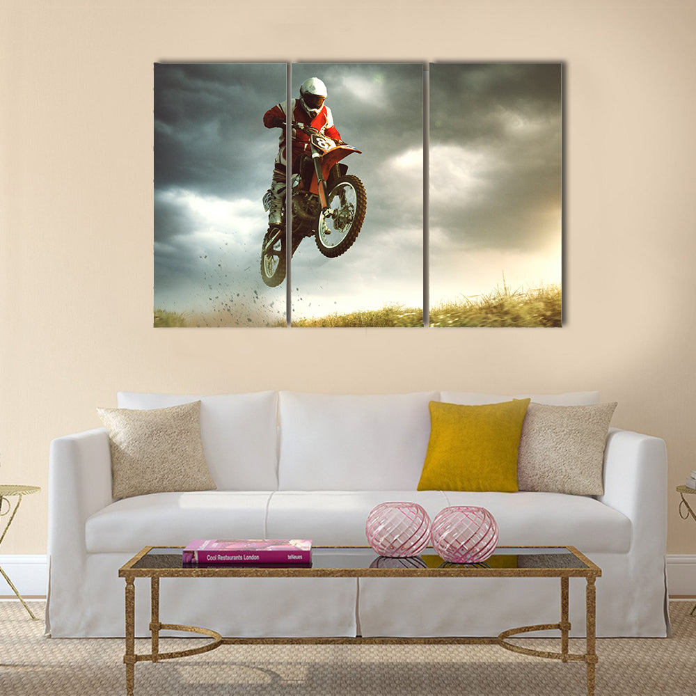 A canvas of a biker making a stunt and jumps in the air Multi panel canvas wall art