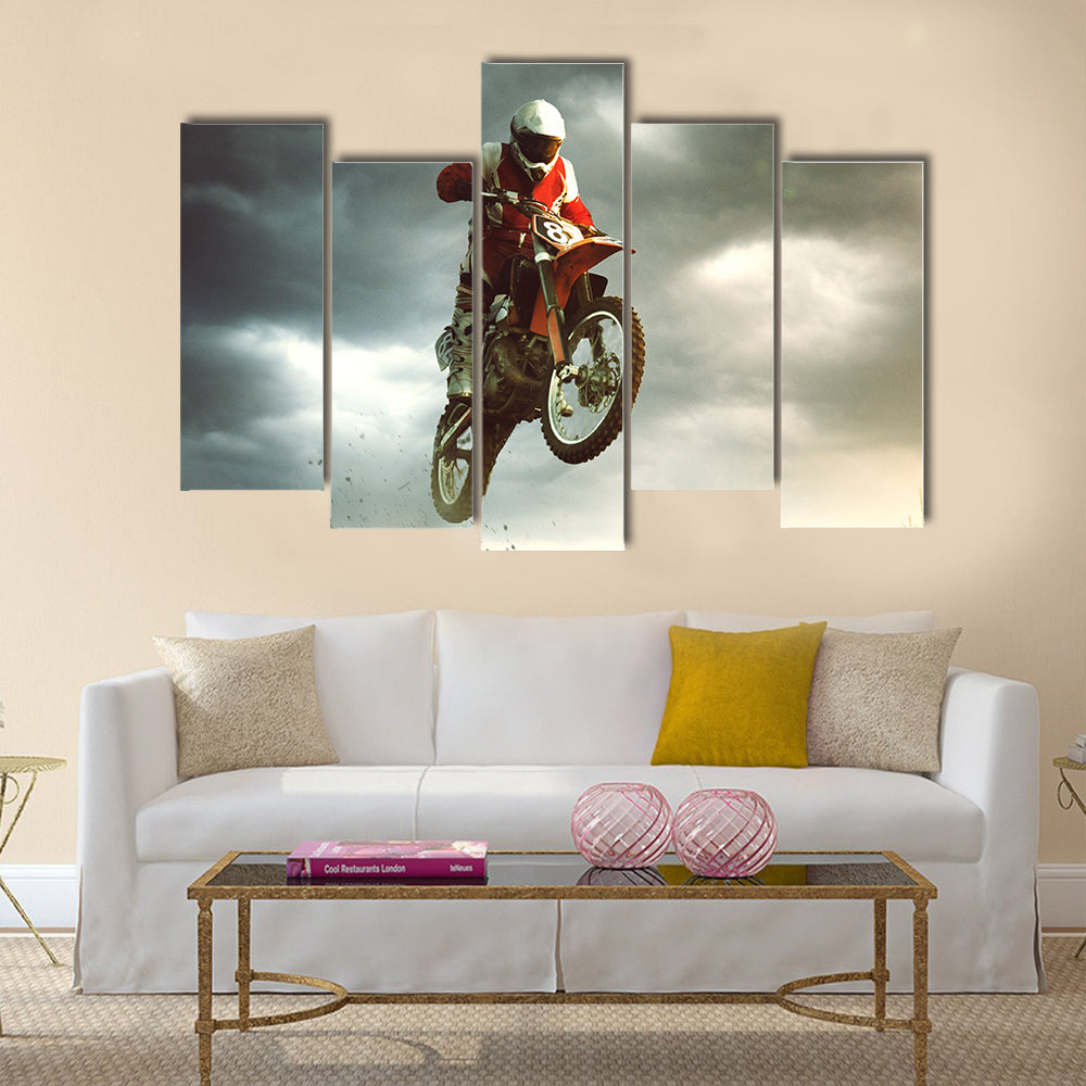 A canvas of a biker making a stunt and jumps in the air Multi panel canvas wall art