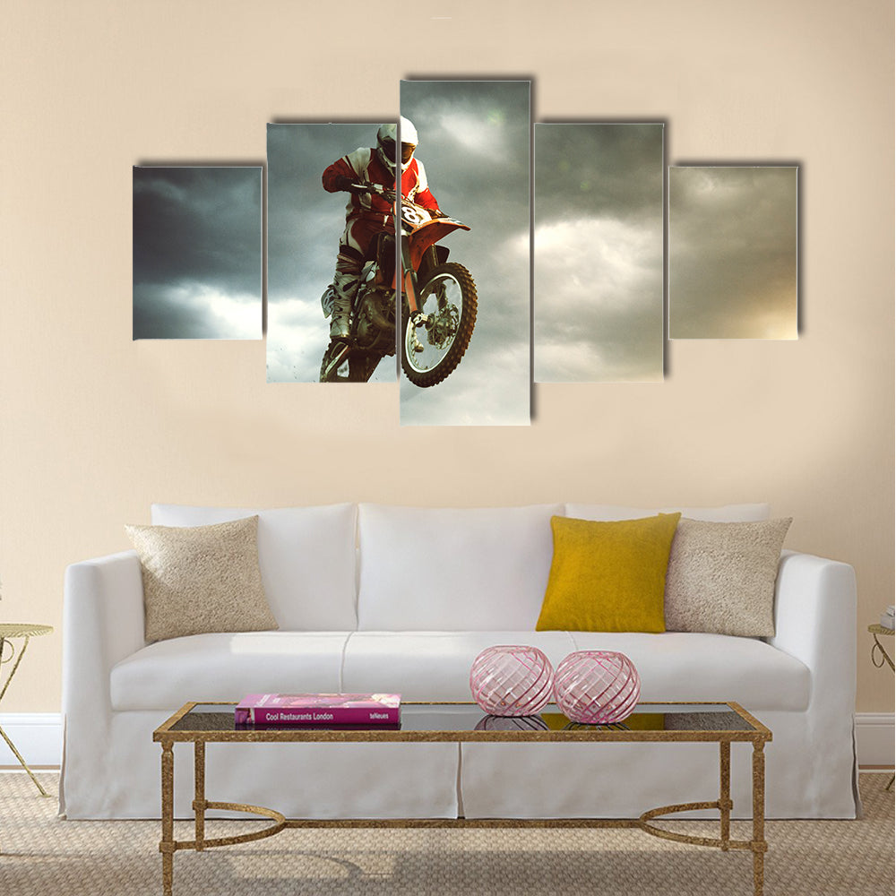 A canvas of a biker making a stunt and jumps in the air Multi panel canvas wall art