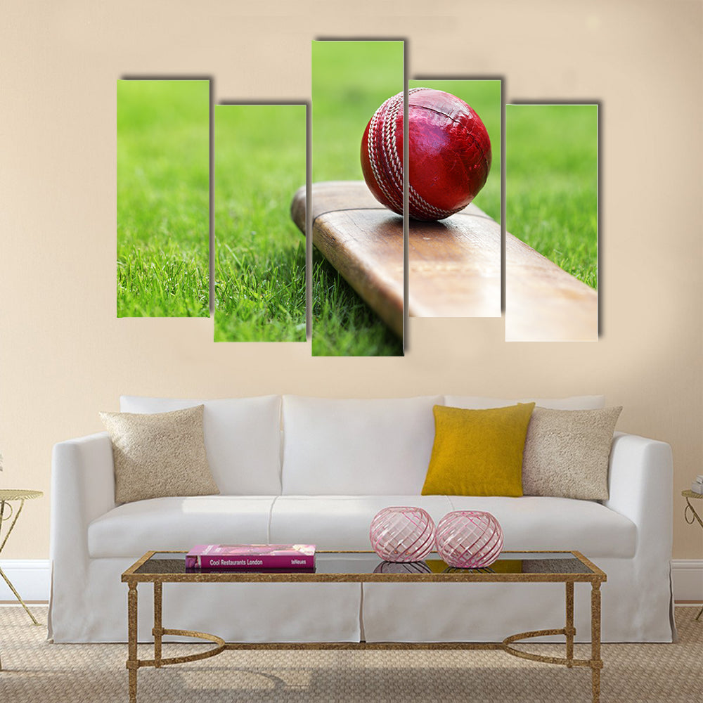 cricket bat on green grass of cricket pitch Multi panel canvas Wall art