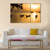 Sunset with palm on tropical beach. multi panel canvas wall art