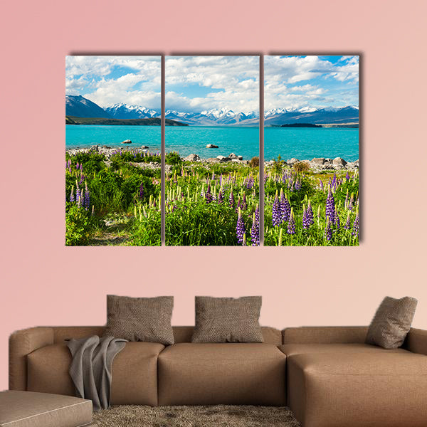 Beautiful incredibly blue Lake Tekapo with blooming lupins multi panel canvas wall art