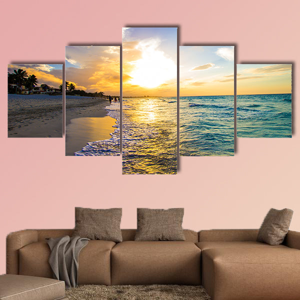 Sandy beach with the ocean at sunset Multi panel canvas wall art