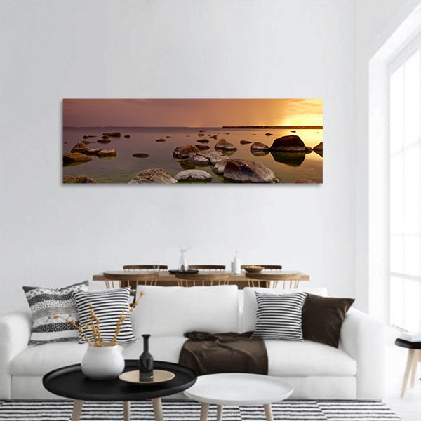 Sunset on sea shore on Baltic sea in Tallinn, Estonia with rocks panoramic canvas wall art