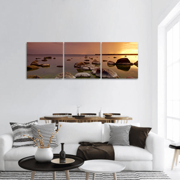 Sunset on sea shore on Baltic sea in Tallinn, Estonia with rocks panoramic canvas wall art