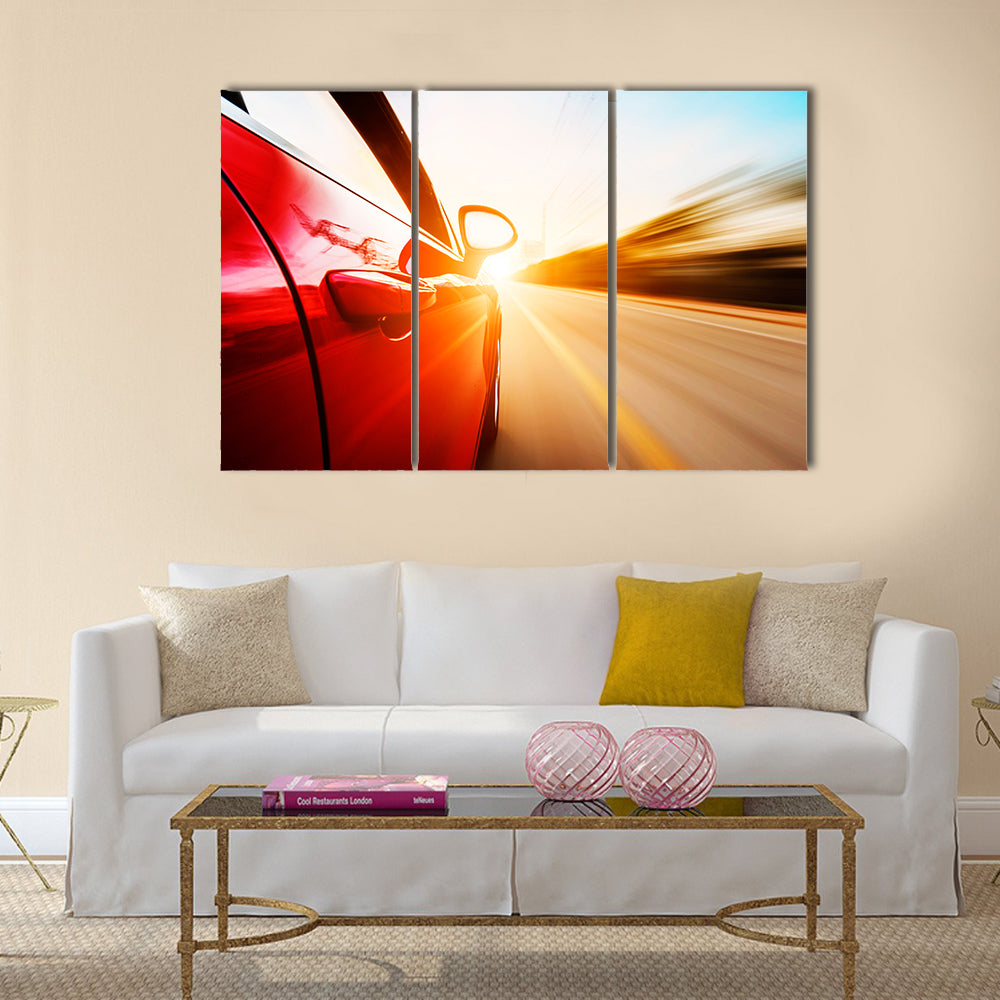 A red car driving on a motorway at high speeds, overtaking other cars Multi panel canvas wall art
