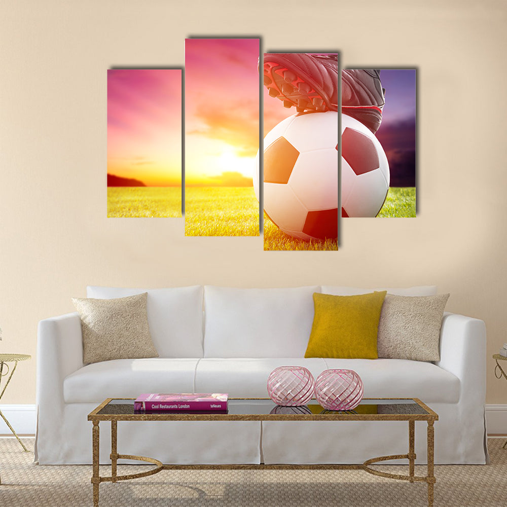 Football or soccer ball at the kickoff of a game with sunset Multi panel canvas wall art