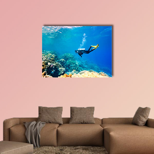 Female scuba diver swimming under water Multi panel canvas wall art