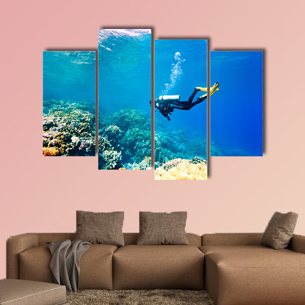 Female scuba diver swimming under water Multi panel canvas wall art