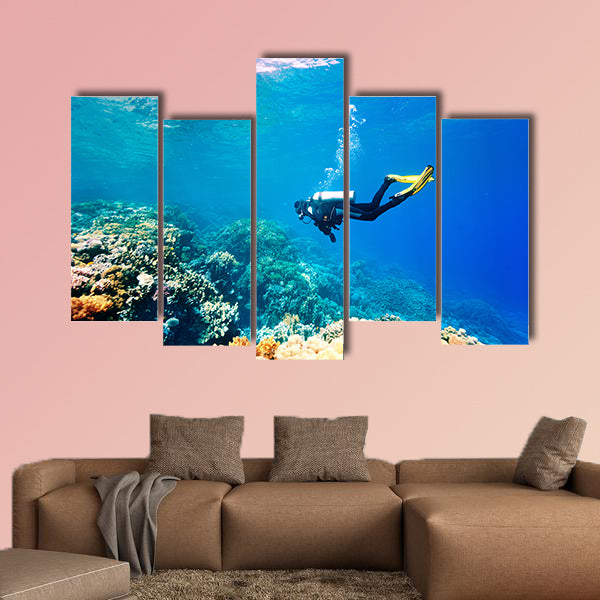 Female scuba diver swimming under water Multi panel canvas wall art