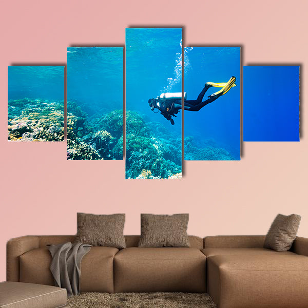 Female scuba diver swimming under water Multi panel canvas wall art