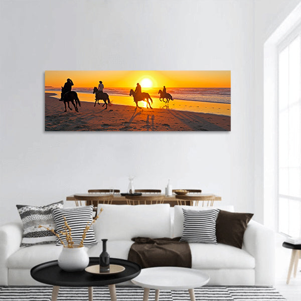 Horse riding on the beach at sunset panoramic canvas wall art