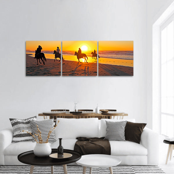 Horse riding on the beach at sunset panoramic canvas wall art