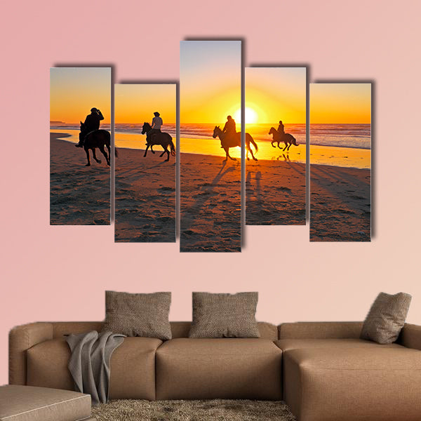 Horse riding on the beach at sunset multi panel canvas wall art